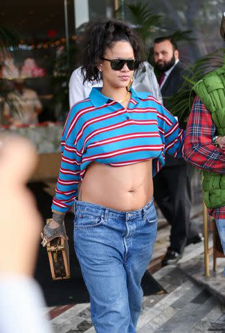 Rihanna shows sweet baby bump in leather jacket for Louis Vuitton