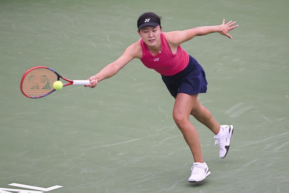 Lin Zhu, from China, lunges for the ball during her first round match against Karolina Pliskova, from the Czech Republic, at the National Bank Open tennis tournament in Montreal, Monday, Aug. 7, 2023. (Graham Hughes/The Canadian Press via AP)