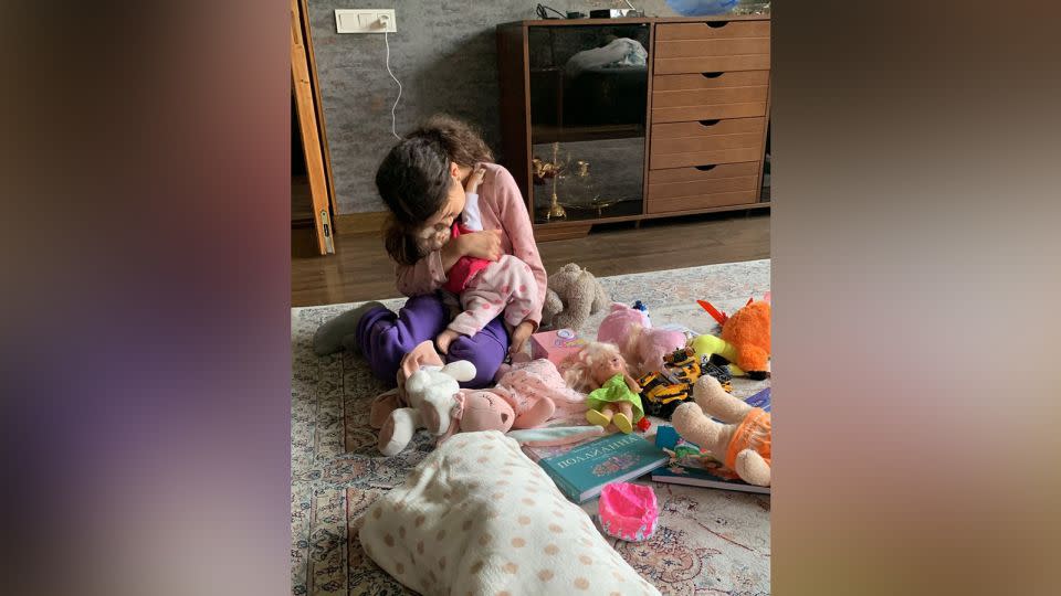 Poghosyan's daughter, aged 9, says goodbye to some of her toys. - Nonna Poghosyan