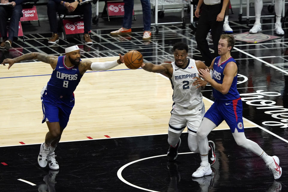 Memphis Grizzlies forward Xavier Tillman (2) vies for loose ball against Los Angeles Clippers forward Marcus Morris Sr., left, and guard Luke Kennard during the second half of an NBA basketball game Wednesday, April 21, 2021, in Los Angeles. (AP Photo/Marcio Jose Sanchez)