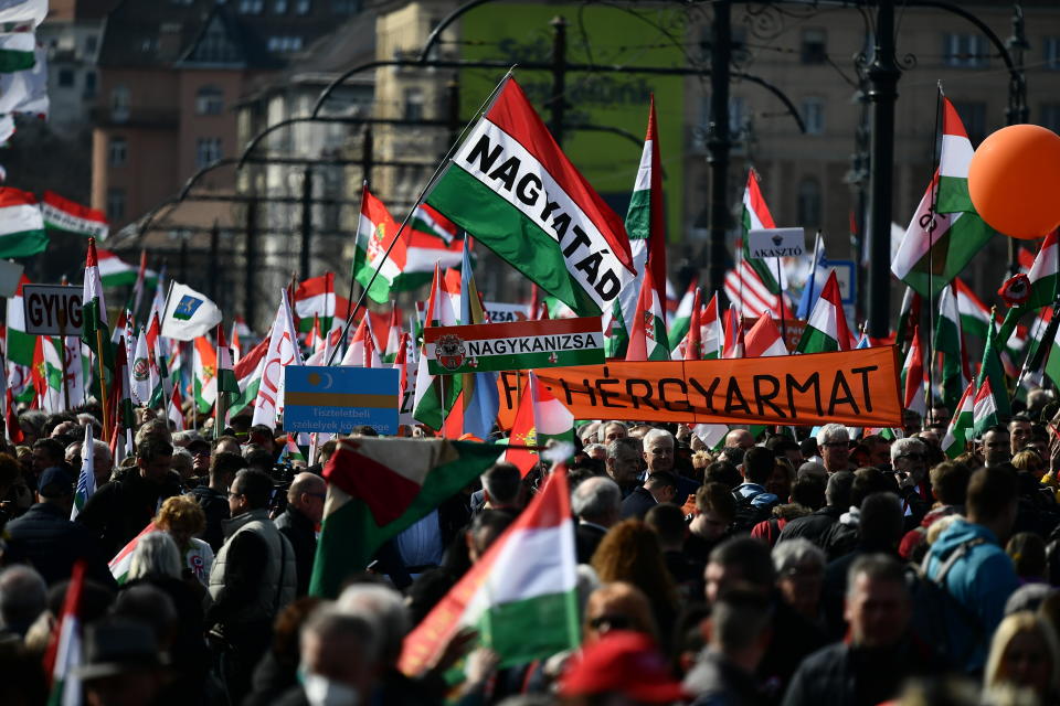 Supporters of Hungary's right-wing populist prime minister, Viktor Orban, gather in Budapest, Hungary, Tuesday, March 15, 2022. The so-called "peace march" was a show of strength by Orban's supporters ahead of national elections scheduled for April 3, while a coalition of six opposition parties also held a rally in the capital. (AP Photo/Anna Szilagyi)