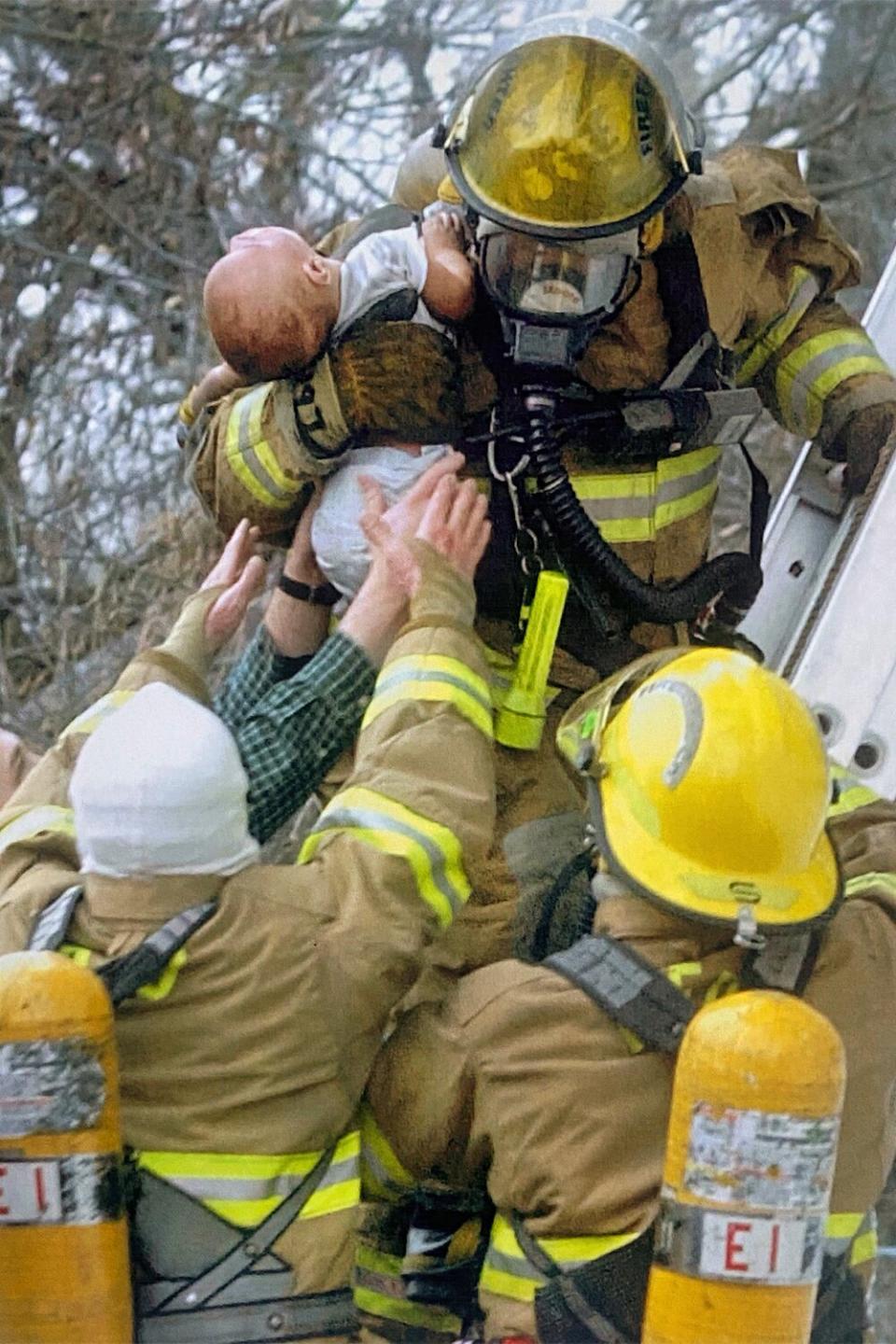 Feb 13, 2001; Richmond, Indiana, USA; Erick All Jr. being rescued from his burning home. Mandatory Credit: Steve Koger-USA TODAY NETWORK