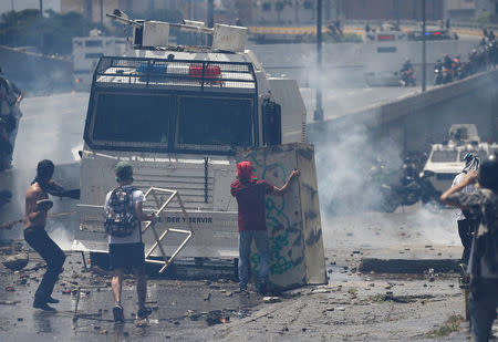 Demonstrators stand in front of a police water cannon during an opposition rally in Caracas, Venezuela April 6, 2017. REUTERS/Carlos Garcia Rawlins