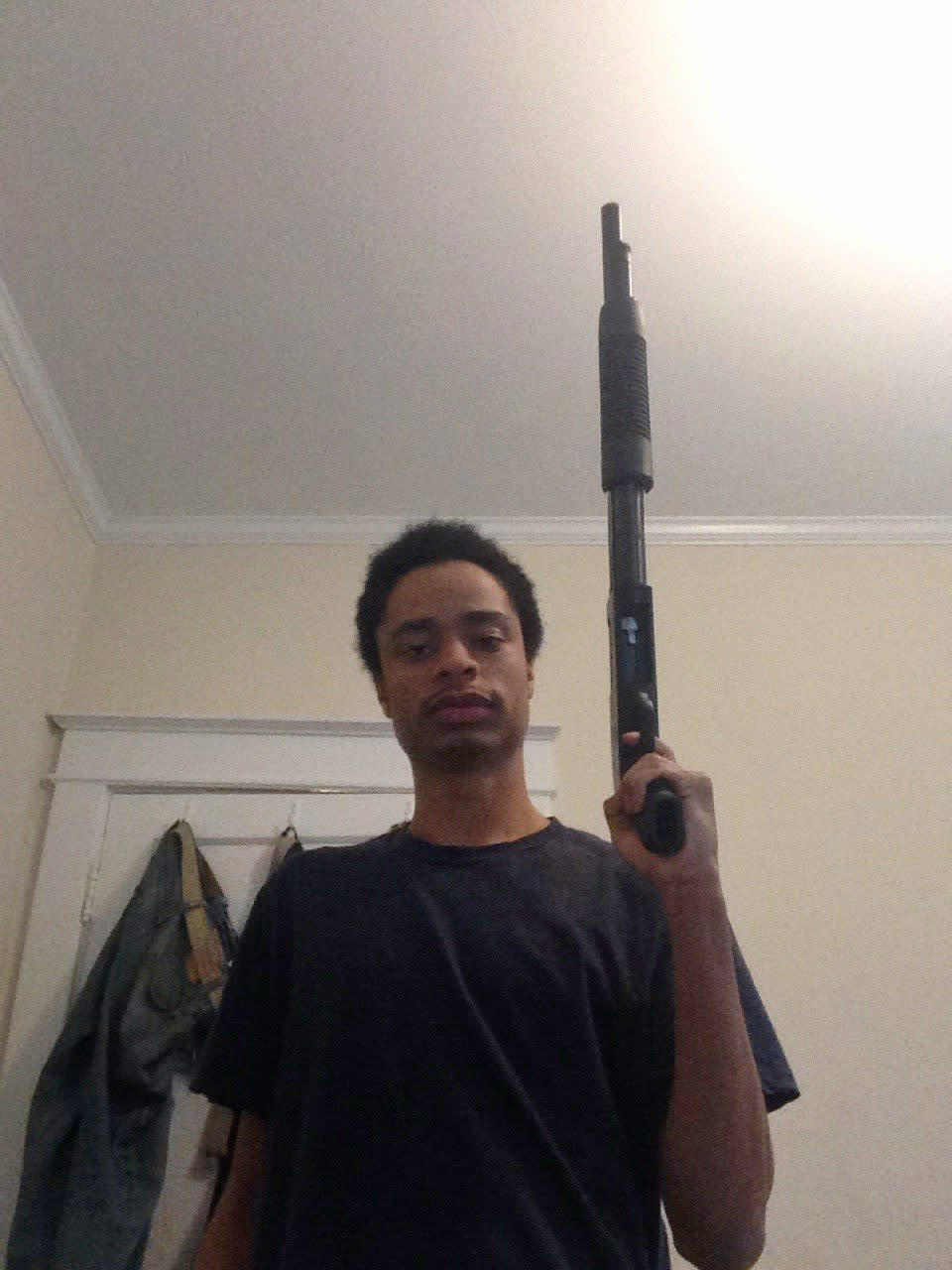 This undated photo provided by the Howard County Police Department shows Darion Marcus Aguilar posing with a shotgun. Aguilar killed two people at a Maryland mall on Jan. 25, 2014, before turning the gun on himself. Police said Wednesday, March 12, that he acted alone, had no connection with his victims and may have had a fixation with the 1999 Columbine High School shooting. (AP Photo/Howard County Police Department)