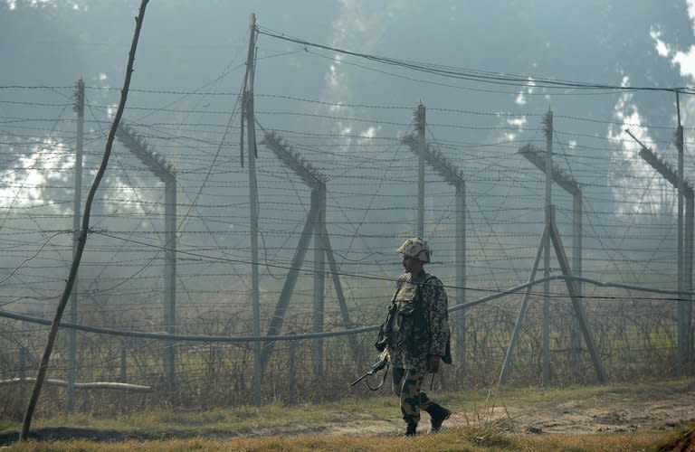 An Indian Border Security Force (BSF) soldier patrols along the border fence with Pakistan in Suchit-Garh, 36 kms southwest of Jammu, on January 10, 2013. Pakistan accused Indian troops of opening fire and killing a Pakistani soldier on Thursday, the third deadly cross-border incident reported in fivedays in the disputed Kashmir region