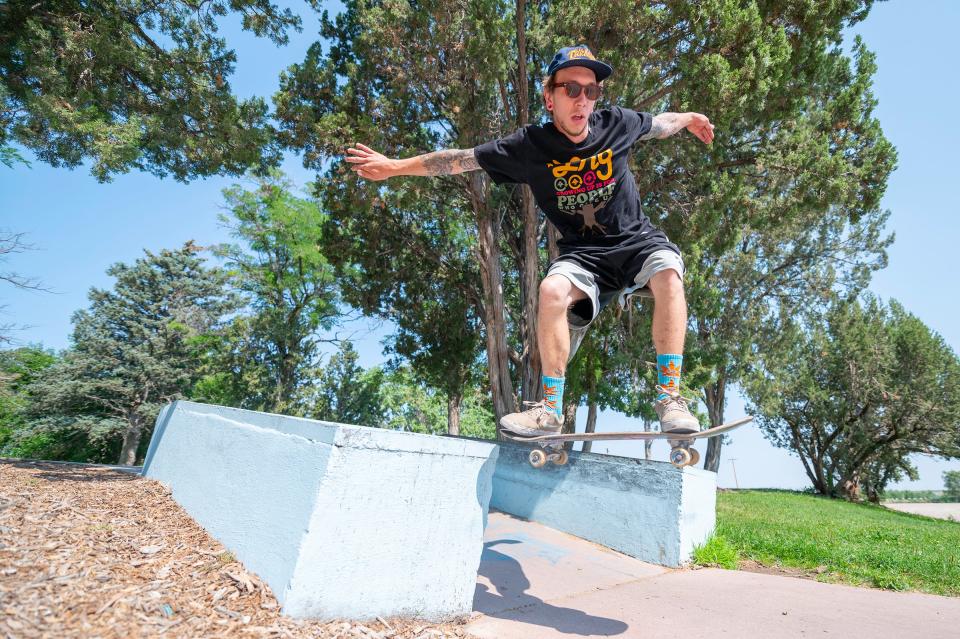 Dylan Johnson dismounts an obstacle at the Sergeant Blake A. Harris Skateboard Park at City Park on Monday July 19, 2021.