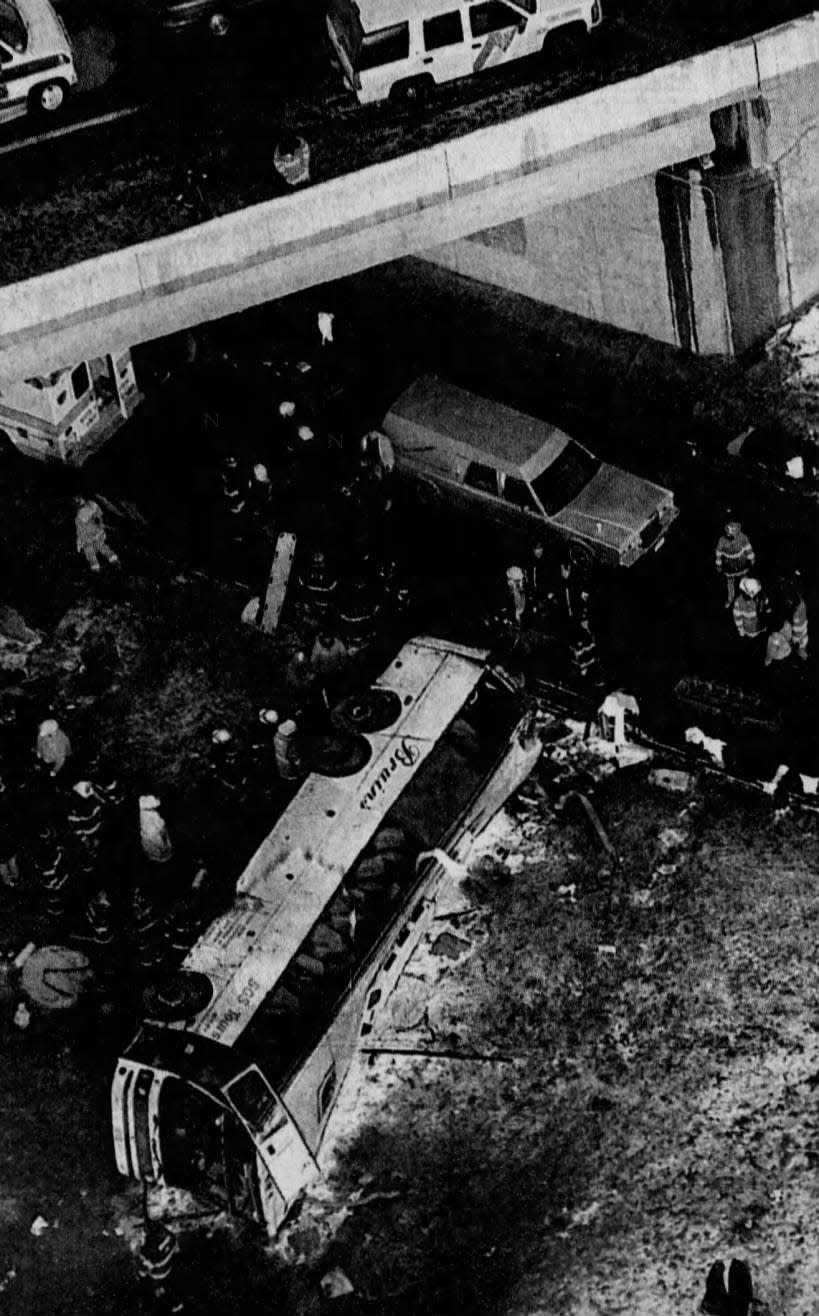 A bus carrying 23 people from Brooklyn, N.Y., to Atlantic City lies on its side after crashing Thursday, Dec. 24, 1998, off the Garden State Parkway in Sayreville.