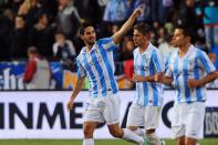 Malaga's midfielder Isco (L) celebrates after scoring during their Spanish league football match against Real Madrid at La Rosaleda stadium in Malaga on December 22, 2012. Real Madrid coach Jose Mourinho was under renewed pressure on Saturday after his team lost 3-2 at Malaga, a defeat which left the champions 16 points behind leaders Barcelona