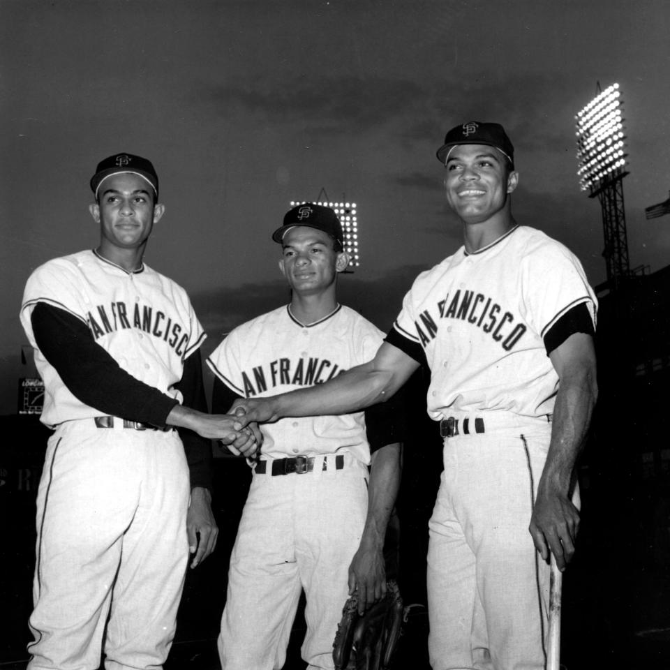 FILE - In this Sept. 10, 1963 file photo, San Francisco outfielders, from left, Jesus Alou, Matty Alou, and Felipe Alou, of the Dominican Republic, pose in a three-way hand shake before start of a baseball game with the New York Mets at New York's Polo Grounds. Matty Alou died in his native Dominican Republic. He was 72. His former Dominican team, Leones del Escogido, said he died Thursday, N ov. 3, 2011 of complications related to diabetes.  (AP Photo/File)