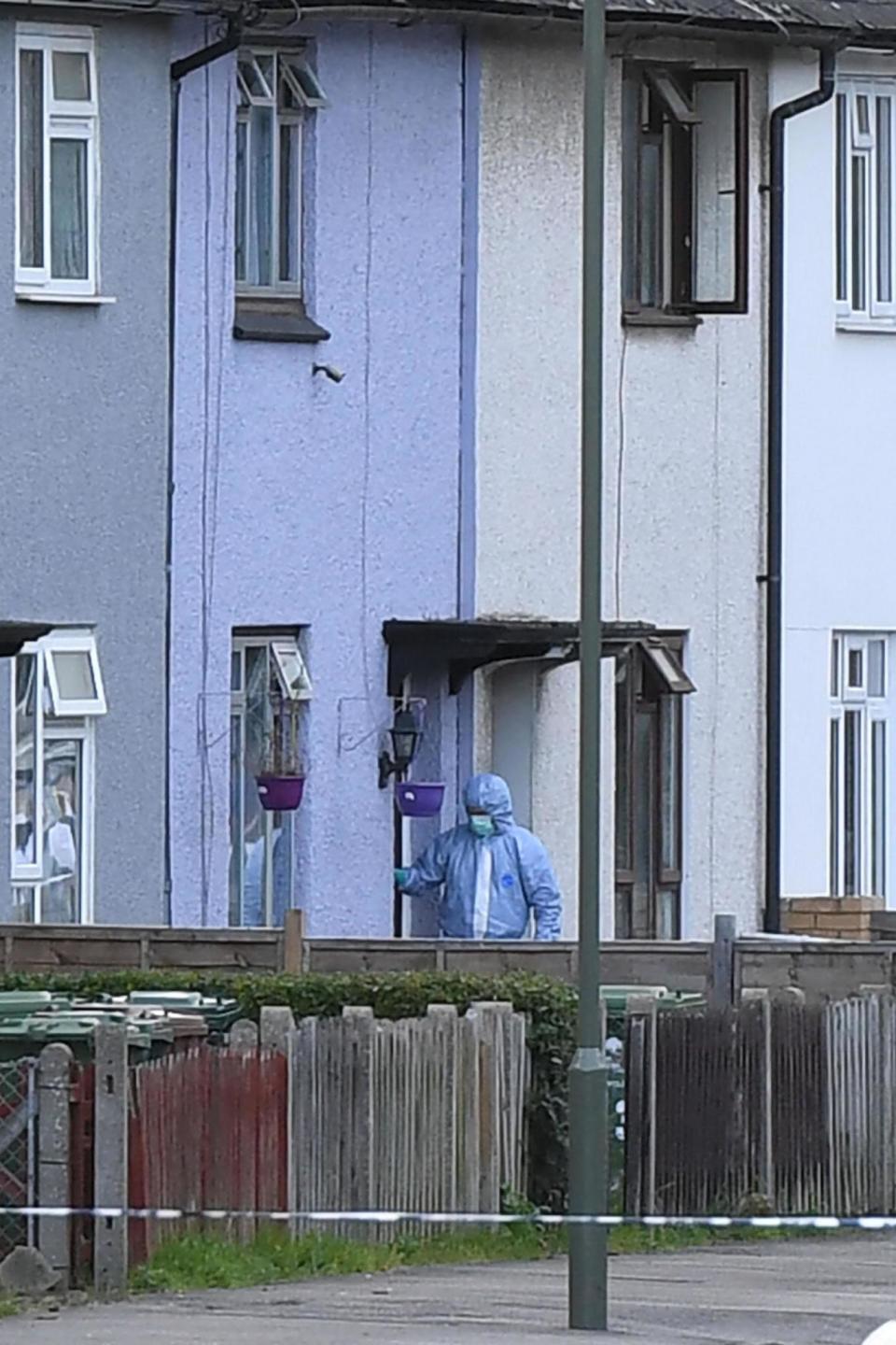 Raid: An investigator stands outside a house amid the search (AFP/Getty Images)