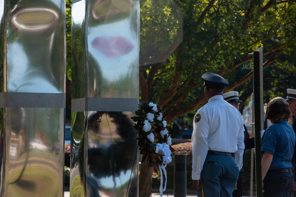 Police, fire and rescue officials participate in a wreath laying ceremony to commemorate the 20th anniversary of 9/11 in Hattiesburg, Miss., Sept. 11, 2021.