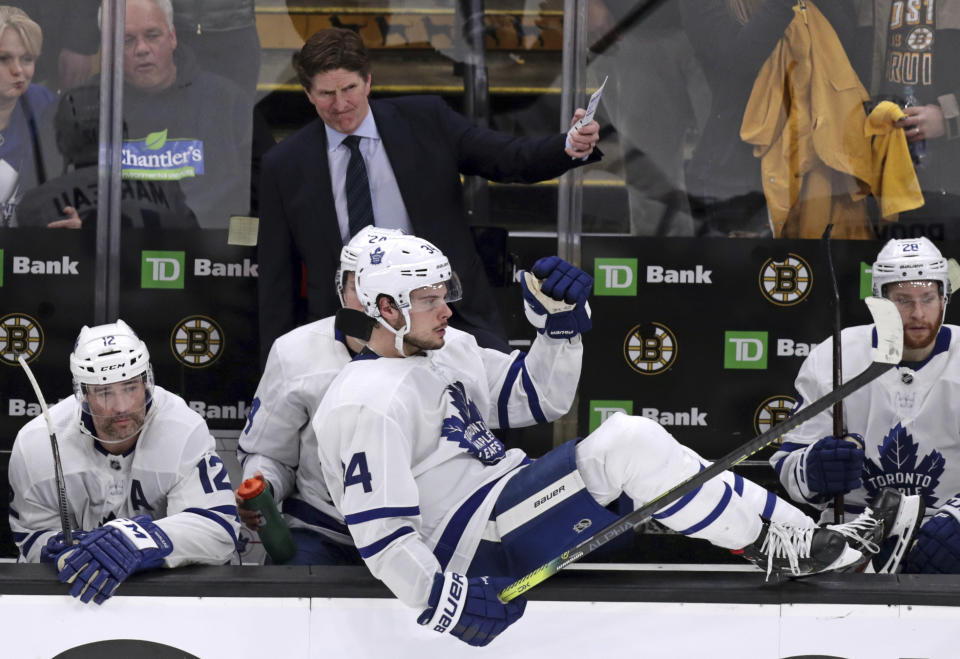 Toronto Maple Leafs center Auston Matthews (34) sits on the boards as head coach Mike Babcock gestures to his players on ice during the final seconds of the third period against the Boston Bruins in Game 7 of an NHL hockey first-round playoff series, Tuesday, April 23, 2019, in Boston. The Bruins won 5-1, eliminating the Leafs. (AP Photo/Charles Krupa)