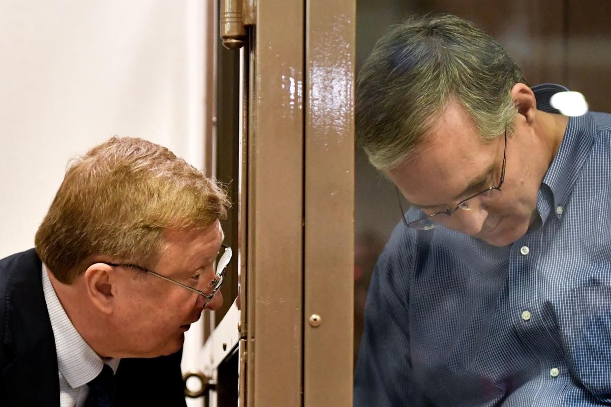 Paul Whelan listens to his lawyers while standing inside a defendants' cage during a hearing at a court in Moscow on January 22, 2019.