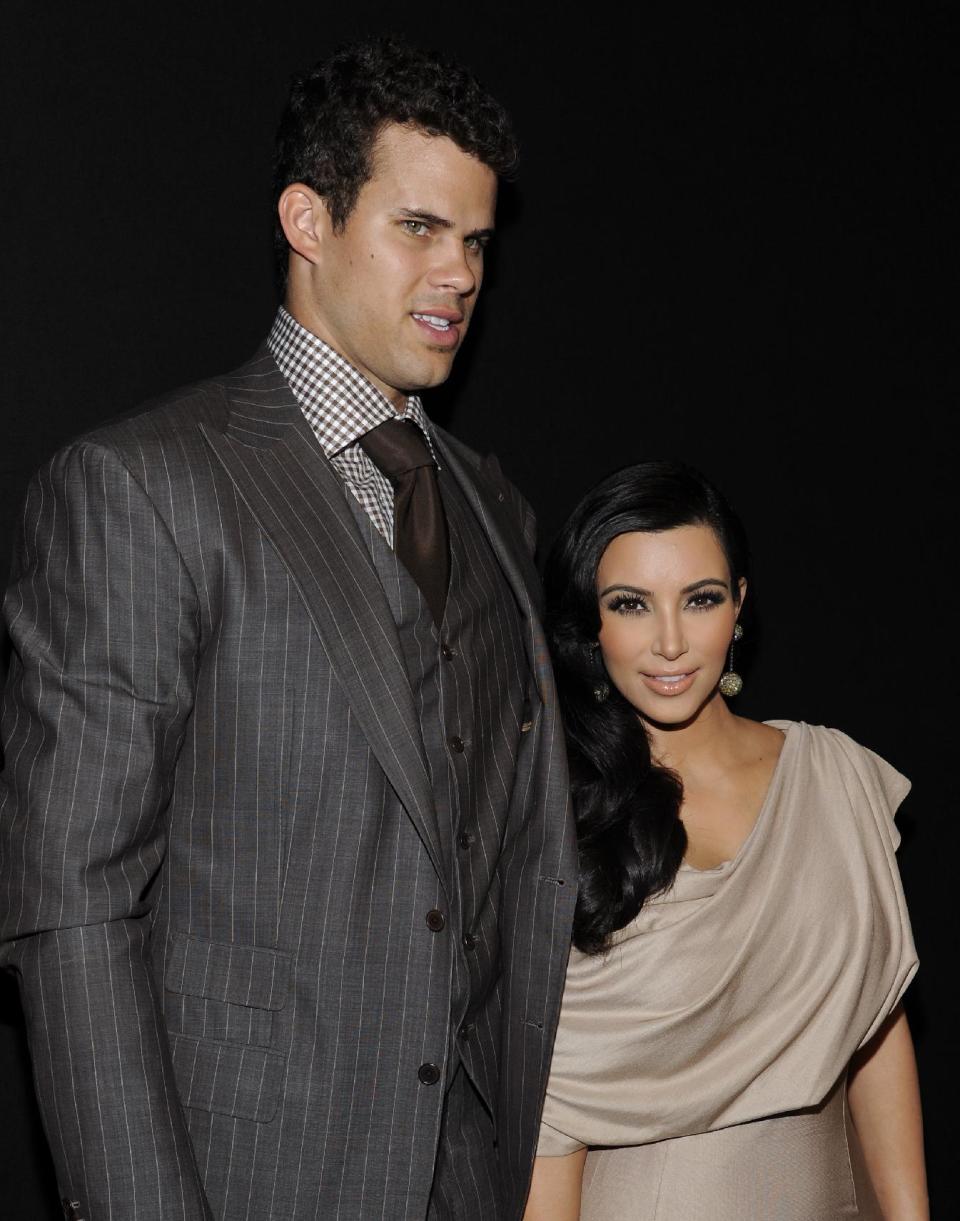 FILE - In this Aug. 31, 2011 file photo, newlyweds Kim Kardashian and Kris Humphries attend a party thrown in their honor at Capitale in New York. Attorneys for Kardashian and Humphries are due in a Los Angeles courtroom on Friday, Feb. 15, 2013 to argue over a trial date to end the couple’s 72-day marriage. Humphries is seeking to delay the case until after the NBA season is over, while Kardashian wants the marriage ended as soon as possible. (AP Photo/Evan Agostini, File)