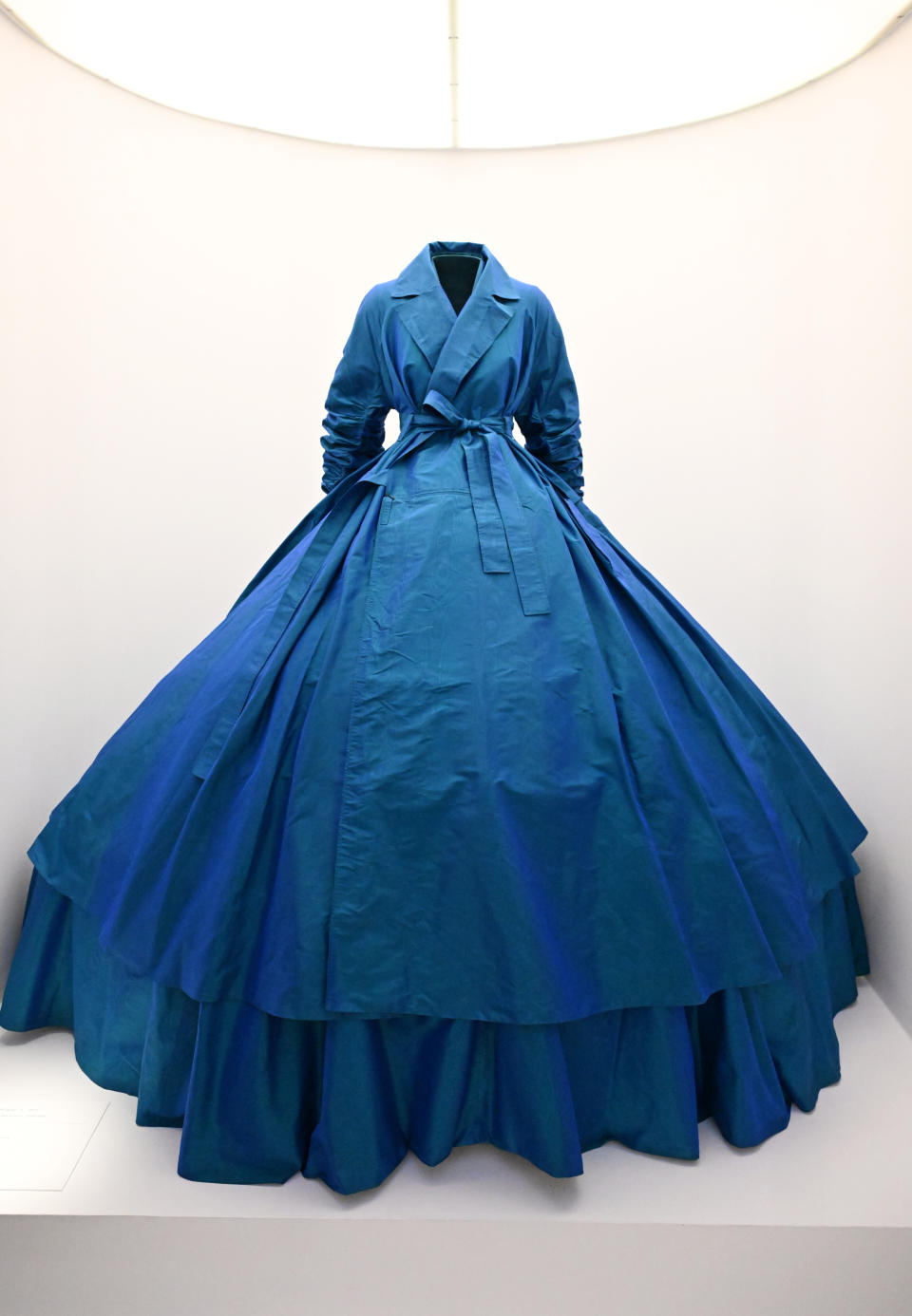 Elegant blue gown displayed on a mannequin with a voluminous skirt and fitted bodice
