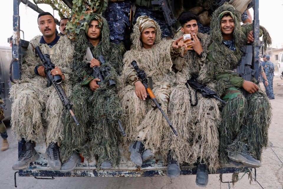 <p>Members of Iraqi Federal Police wearing snipers camouflage ride a truck after a parade rehearsal to celebrate victory of military operations against the Islamic State militants in West Mosul, Iraq July 2, 2017. (Photo: Erik De Castro/Reuters) </p>