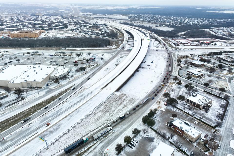 An icy mix covers Highway 114 on Monday in Roanoke, Texas. Dallas and other parts of North Texas are under a winter storm warning through Wednesday.
