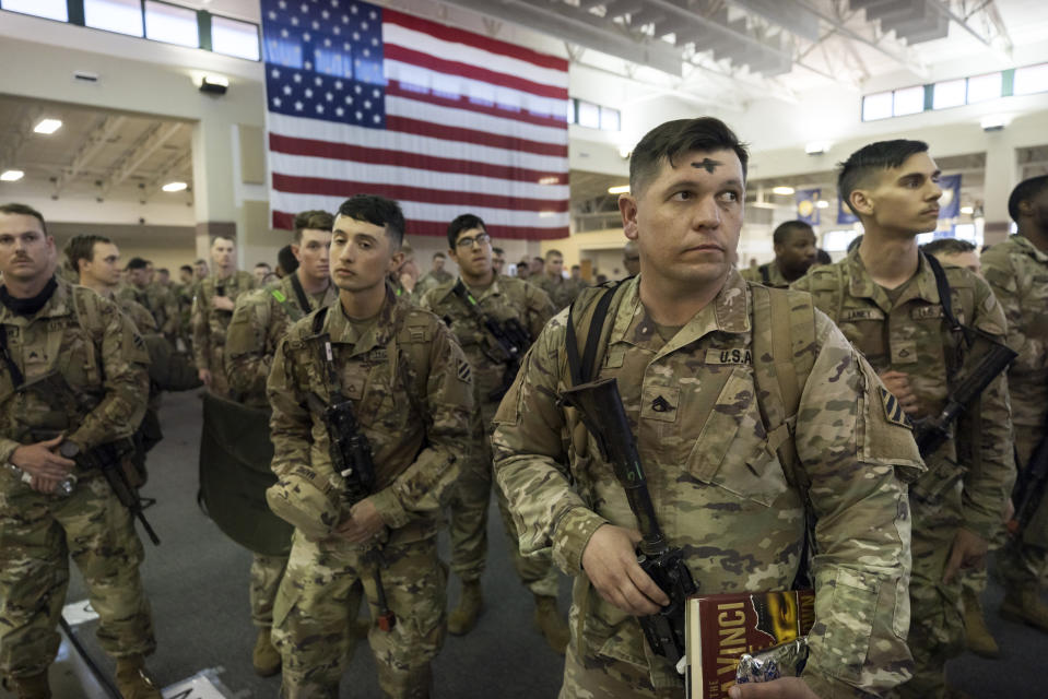 Some of the soldiers with the U.S. Army 3rd Infantry Division, 1st Armored Brigade Combat Team celebrated Ash Wednesday before being deployed to Germany from Hunter Army Airfield, Wednesday March 2, 2022 in Savannah, Ga. The division is sending 3,800 troops as reinforcements for various NATO allies in Eastern Europe. (Stephen B. Morton /Atlanta Journal-Constitution via AP)