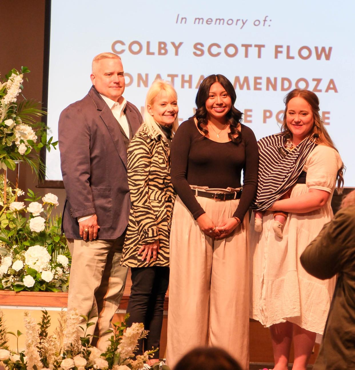 The family of Colby Scott Pool stand with Leticia Lora, a recipient of a scholarship in his memory Friday at a student memorial service at West Texas A&M in Canyon.