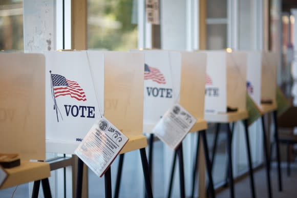 A U.S. polling booth with attached election pamphlet.