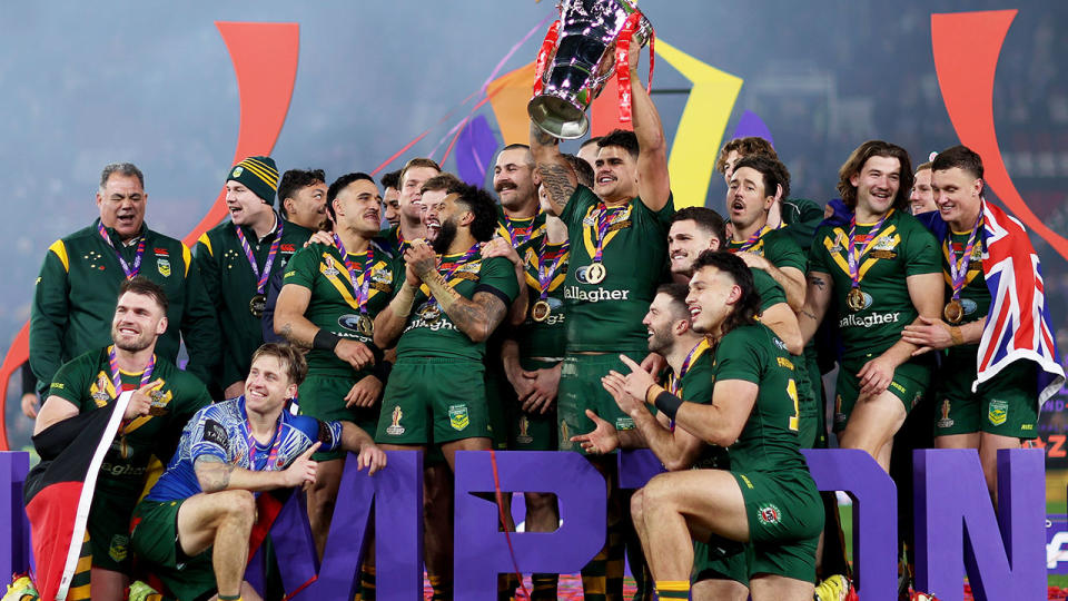 Australia celebrates with the Rugby League World Cup trophy after winning the tournament final.