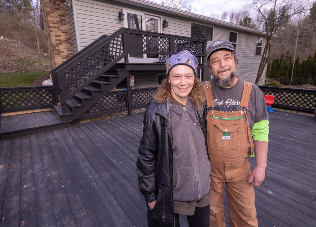 Chandra Potschner of Stark County and her husband William "Toby" Potschner pose with the home they recently purchased in the Bolivar area after Chandra won $500,000 with an Ohio Lottery scratch-off game last year. The couple also will appear in a future episode of HGTV's "My Lottery Dream Home."