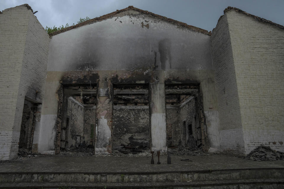 Russian ordinance on the ground of a concert hall damaged by strikes, in Yahidne village, northern Chernihiv region, Ukraine, Wednesday, June 29, 2022. A few months after Russian troops retreated from Yahidne, the village has gradually returned to life. People are repairing their homes, and a strong wind occasionally picks up the bitter smell of ashes. (AP Photo/Nariman El-Mofty)