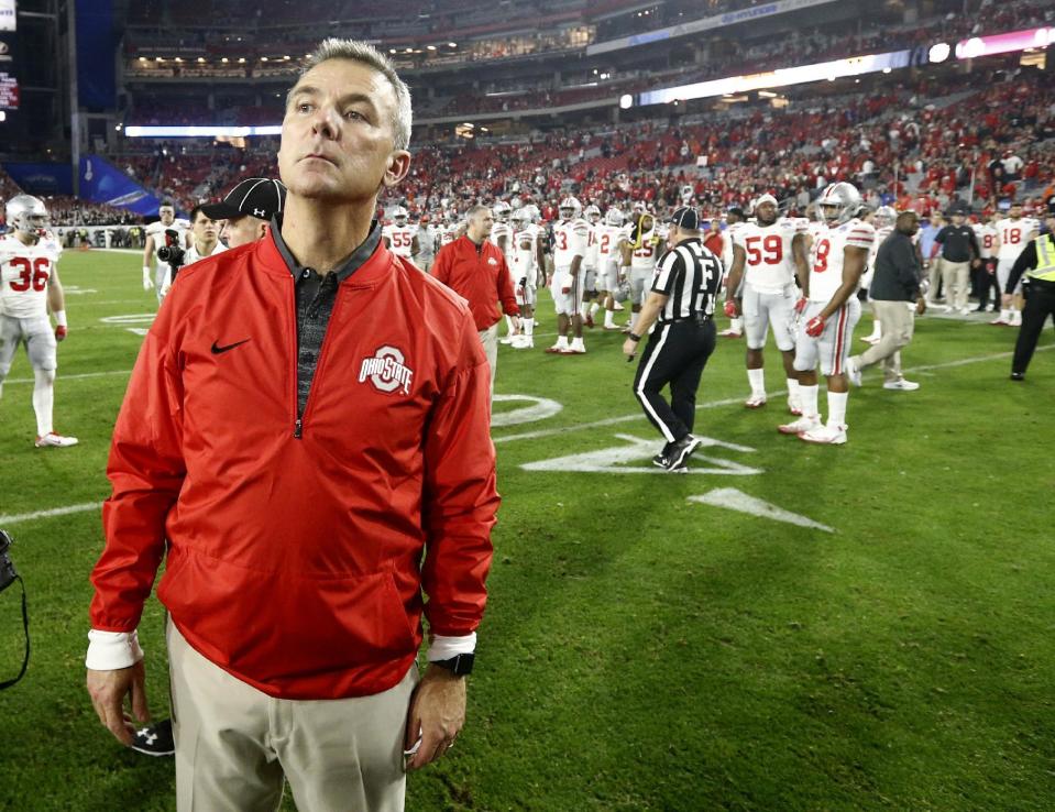 Ohio State coach Urban Meyer stands at midfield after the team's Fiesta Bowl NCAA college football playoff semifinal against Clemson, Saturday, Dec. 31, 2016, in Glendale, Ariz. Clemson won 31-0 to advance to the BCS championship game Jan. 9 against Alabama. (AP Photo/Ross D. Franklin)