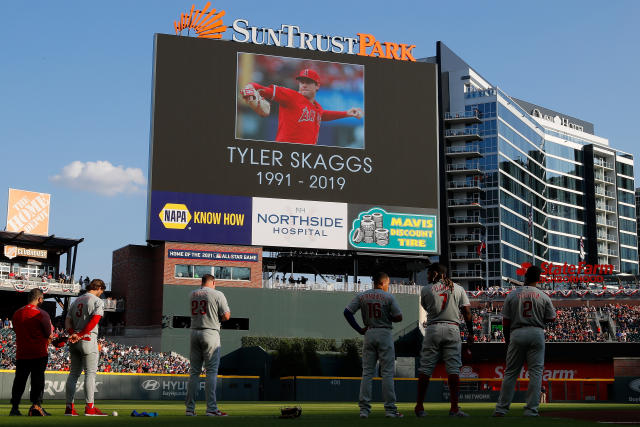 Miguel Gonzalez places a hat at a memorial for Los Angeles Angels pitcher Tyler  Skaggs outside Angel Stadium in Anaheim, Calif., Tuesday, July 2, 2019. The  27-year-old left-hander died in his Texas