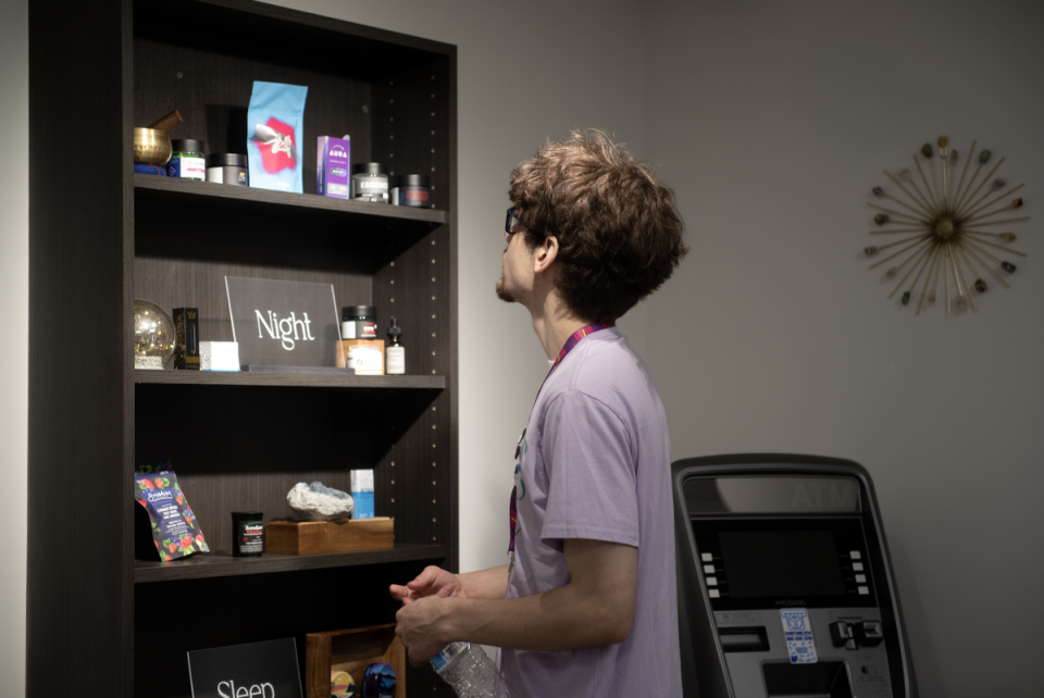 Ben Bowman, Bliss Ohio employee, checks on display focused on sleep products at the new medical marijuana dispensary in Kent.