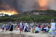 <p>Fin juillet, de nombreux campeurs et vacanciers sont surpris en pleine nuit par les flammes dans le Var. À Bormes-les-Mimosas, commune touristique du département, des milliers de personnes sont évacuées et trouvent refuge sur la plage. Au total, 4000 hectares de végétation et de garrigue sont partis en fumée dans le Var. (Photo AFP) </p>