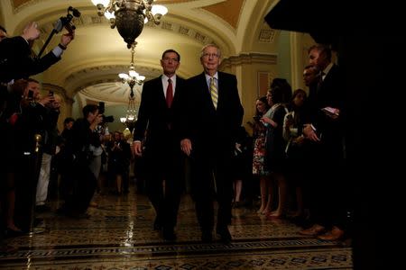 Senate Majority Leader Mitch McConnell, accompanied by Sen. John Barrasso (R-WY), arrives to speak to the media about plans to repeal and replace Obamacare on Capitol Hill in Washington, U.S., June 27, 2017. REUTERS/Aaron P. Bernstein