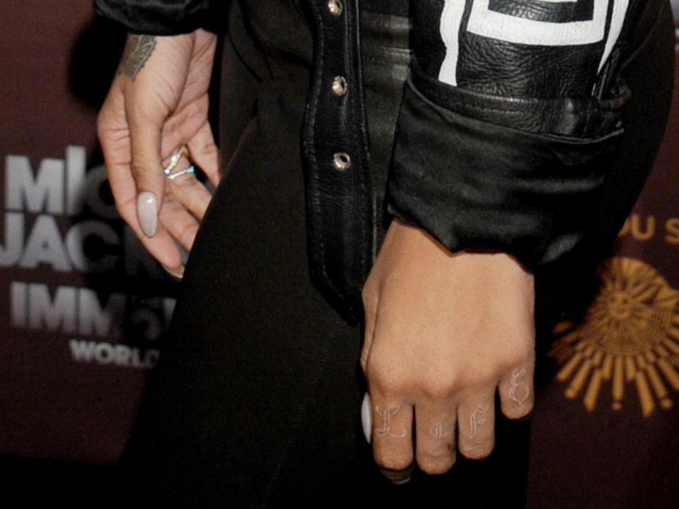 Rihanna (tattoo detail) arrives at Los Angeles Opening of "Michael Jackson THE IMMORTAL World Tour" at Staples Center on January 27, 2012 in Los Angeles, California