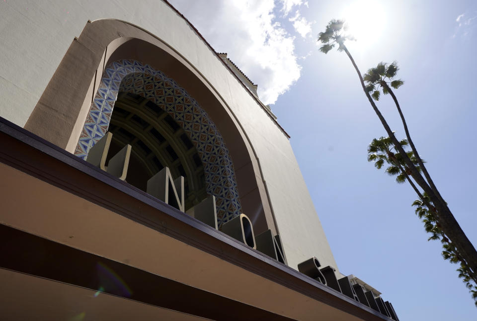 The exterior of Union Station in Los Angeles appears on March 23, 2021. The Oscars are headed to the historic site for the first time this year. With wide open spaces and 65-foot high ceilings, it’s ideal for a big crew and cameras. It’s been used in car commercials, reality shows and procedurals. But its beamed ceilings, Spanish tile floors and regal bronze chandeliers really shine in cinema where it’s played train stations, banks, police stations, clubs and airports. (AP Photo/Chris Pizzello)