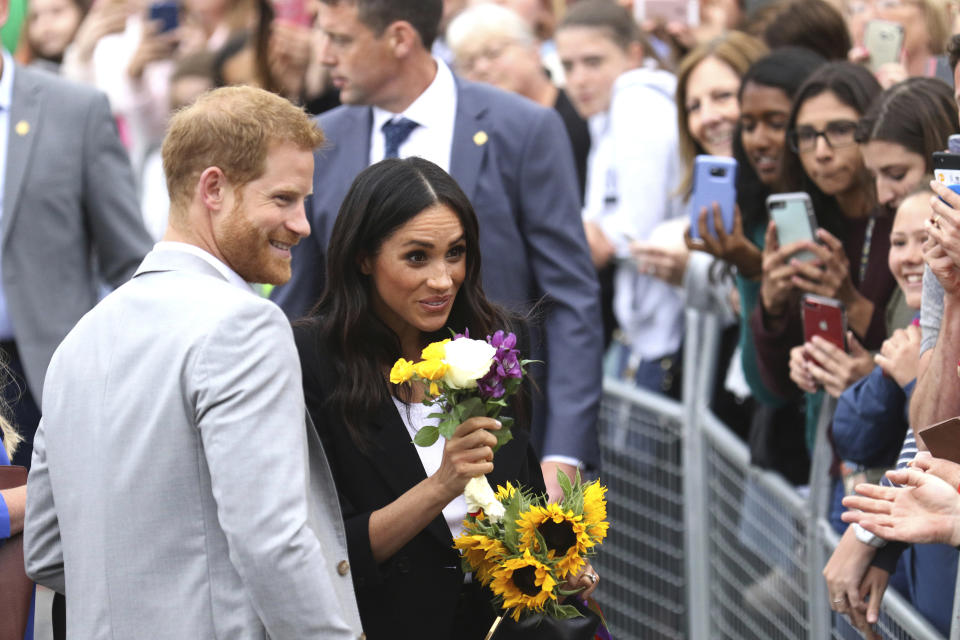 Prince Harry and Meghan , the Duchess of Sussex meeting members of the public in Dublin on Wednesday. (AP)