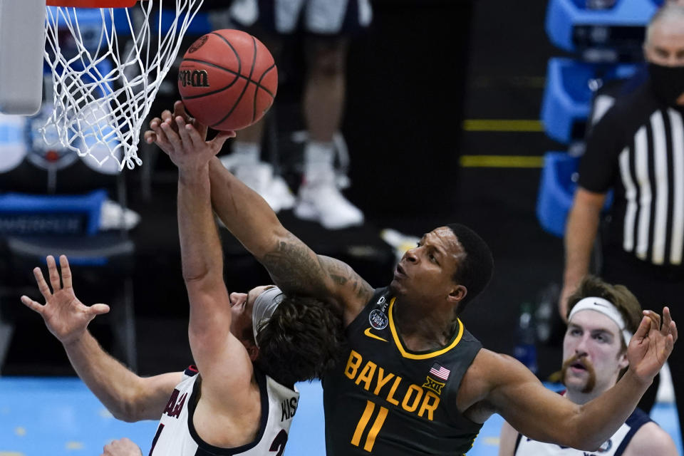 FILE - In this Monday, April 5, 2021 file photo, Baylor guard Mark Vital (11) blocks a shot by Gonzaga forward Corey Kispert during the second half of the championship game in the men's Final Four NCAA college basketball tournament at Lucas Oil Stadium in Indianapolis. The Big 12 Conference is distributing about $345 million of revenue to its 10 schools, the second year in a row the number has been lower because of the COVID-19 pandemic. Commissioner Bob Bowlsby said Tuesday, May 25, 2021 at the end of two days of league board meetings held virtually, that the overall revenue was about $50 million short of what had been expected before COVID-19. (AP Photo/Michael Conroy, File)