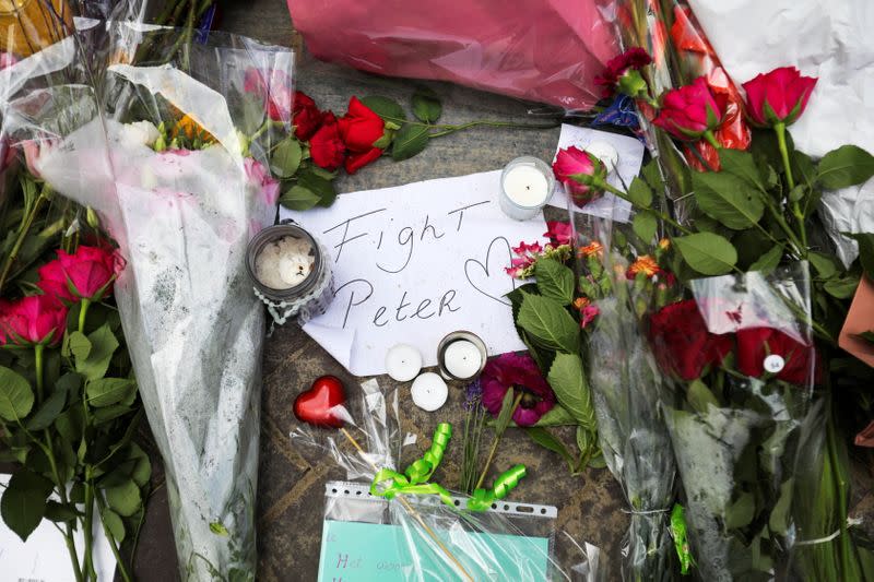 FILE PHOTO: People leave flowers where Dutch crime reporter de Vries has been shot and reported seriously injured in Amsterdam