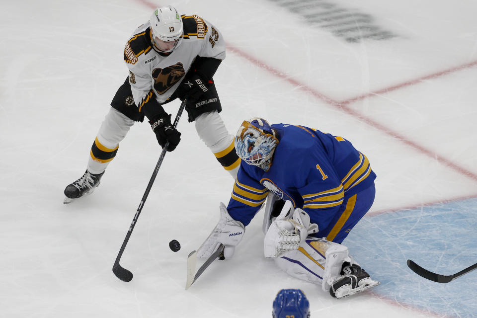 Buffalo Sabres goaltender Ukko-Pekka Luukkonen (1) makes a save on a shot by Boston Bruins center Charlie Coyle (13) during the first period of an NHL hockey game, Saturday, Dec. 31, 2022, in Boston. (AP Photo/Mary Schwalm)