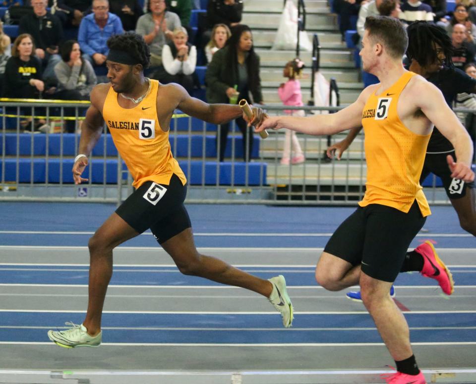 Salesianum's Bishop Lane takes the baton from Jake Portale for the anchor leg as their team wins the 4x200 meter relay during the DIAA indoor track and field championships at the Prince George's Sports and Learning Complex in Landover, Md., Saturday, Feb. 3, 2024.