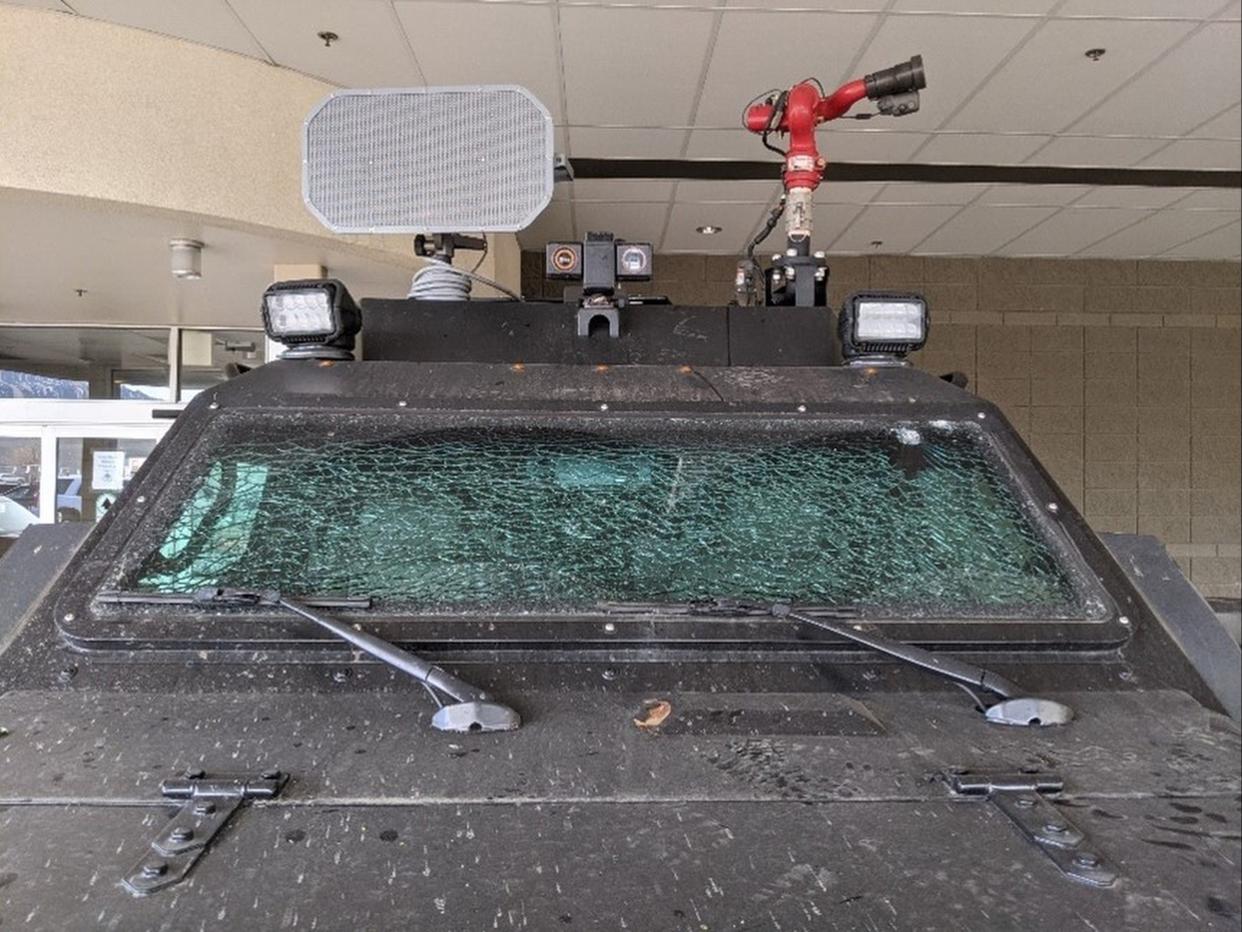 A police vehicle had its windshield smashed after SWAT teams cleared a street party with around 800 people.  (City of Boulder)