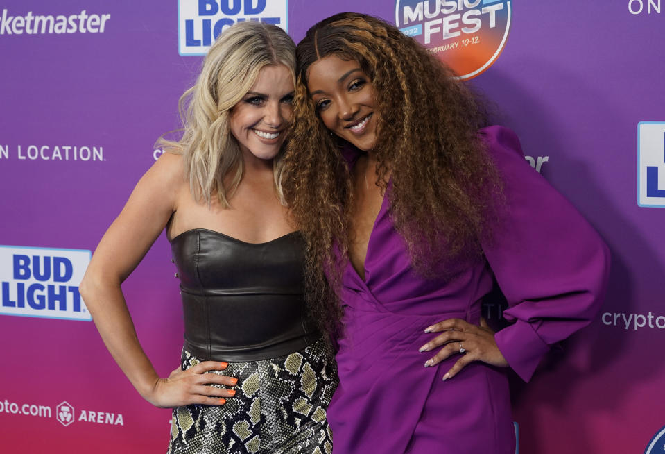 Lindsay Ell, left, and Mickey Guyton arrive at day two of the Bud Light Super Bowl Music Fest on Friday, Feb. 11, 2022, at Crypto.com Arena in Los Angeles. (AP Photo/Chris Pizzello)