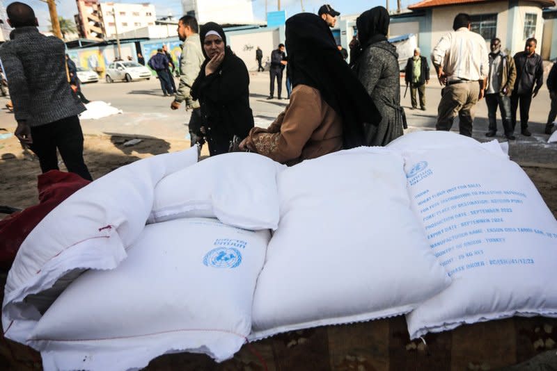 Palestinians receive bags of flour distributed by the United Nations Relief and Works Agency for Palestine Refugees. At least 108 UNRWA workers have been killed in the conflict. Photo by Ismail Muhammad/UPI