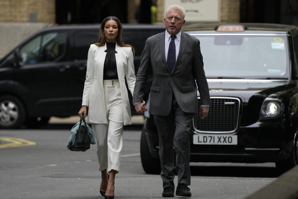 Former Tennis player Boris Becker with Lilian de Carvalho Monteiro as they arrive at Southwark Crown Court for sentencing in London, Friday, April 29, 2022. Becker was found guilty earlier of dodging his obligation to disclose financial information to settle his debts.(AP Photo/Alastair Grant)