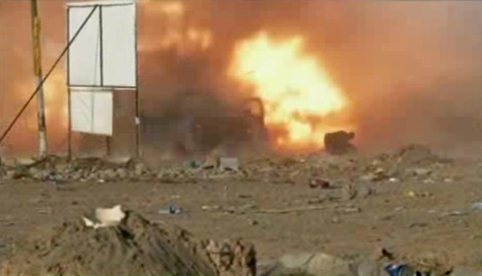 This image made from video shows a car bomb at the moment of impact, one in a series of bombs that exploded Friday, April 25, 2014 at a campaign rally for a Shiite group in Baghdad, Iraq, ahead of the country's parliamentary election. The blasts killed and wounded dozens, officials said. (AP Photo via AP video)