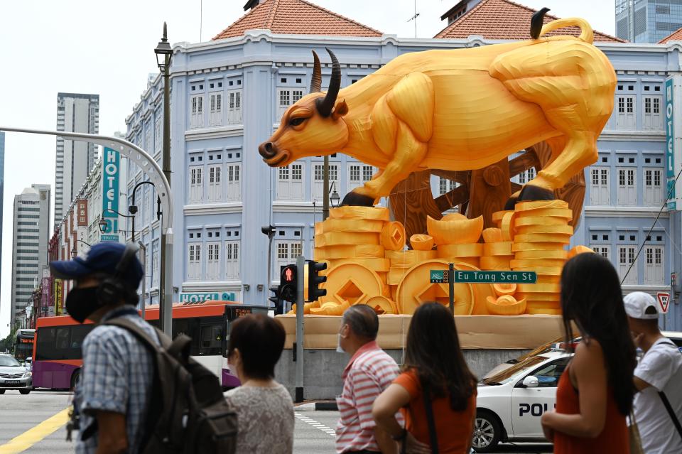 Pedestrians seen near a Chinese New Year decoration marking the Year of the Ox in Singapore's Chinatown district on. (PHOTO: Getty Images)