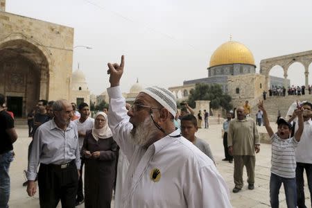 A Palestinian man shouts at a right-wing Jewish activist (unseen) visiting the compound known to Muslims as the Noble Sanctuary and to Jews as Temple Mount, in Jerusalem's Old City May 28, 2015. REUTERS/Ammar Awad