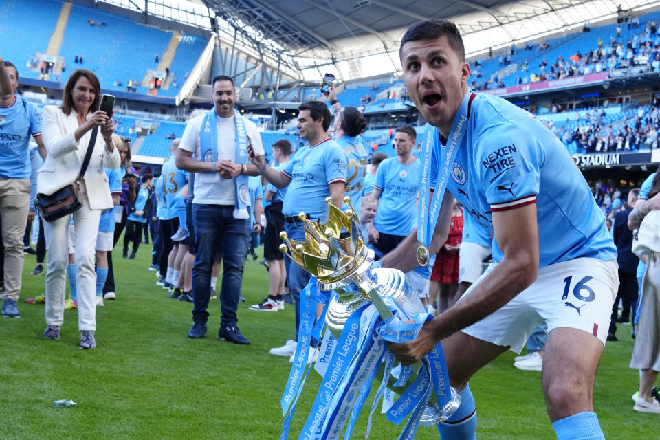 Manchester City's Rodrigo celebrates Premier League title after the English Premier League soccer match between Manchester City and Chelsea at the Etihad Stadium in Manchester, England, Sunday, May 21, 2023. (AP Photo/Jon Super)