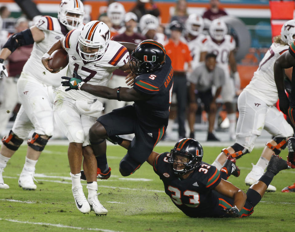 Miami defensive back Amari Carter (5) sacks Virginia Tech quarterback Josh Jackson (17) during the first half of an NCAA college football game, Saturday, Nov. 4, 2017 in Miami Gardens, Fla. (AP Photo/Wilfredo Lee)