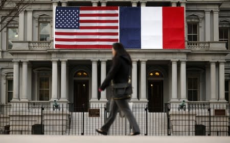 U.S. and French flags fly next to the White House to honor French President Hollande in Washington