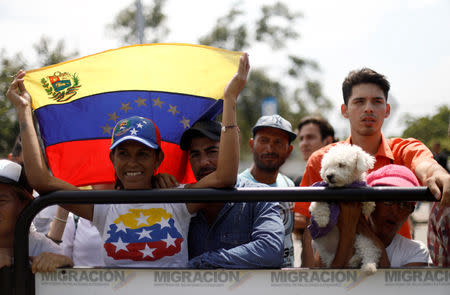 A woman waves a Venezuelan flag as U.S. Senator Marco Rubio visits the Colombia-Venezuela border at the Simon Bolivar International Bridge on the outskirts of Cucuta, Colombia February 17, 2019. REUTERS/Edgard Garrido